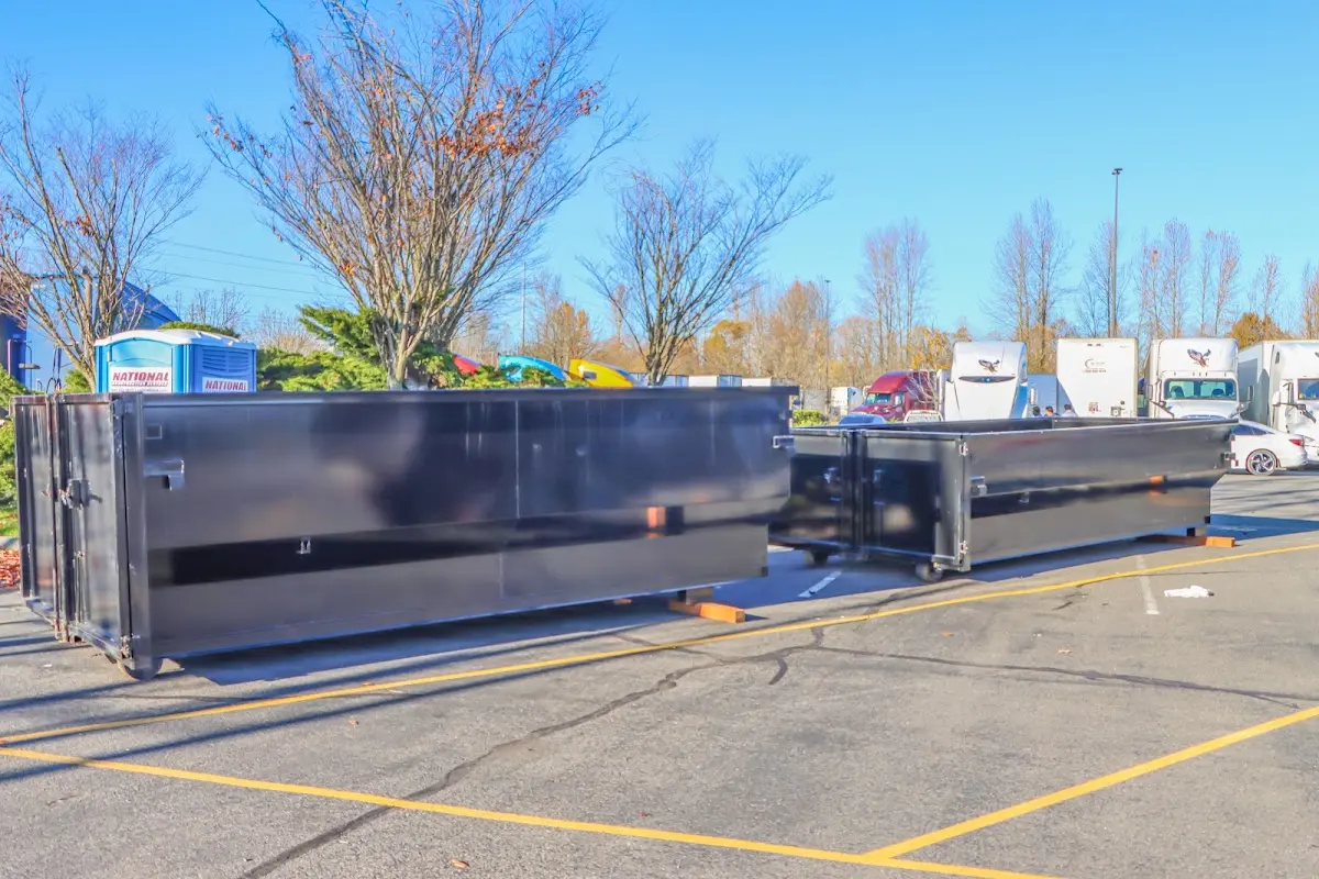 Professional dumpster rental service with roll-off container on residential driveway in Harrodsburg